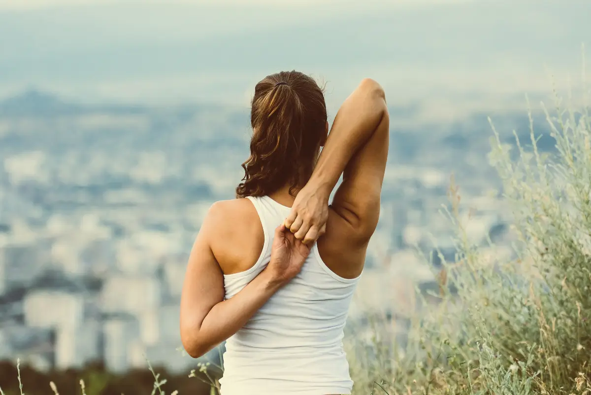 A woman stretching her arms in the air.