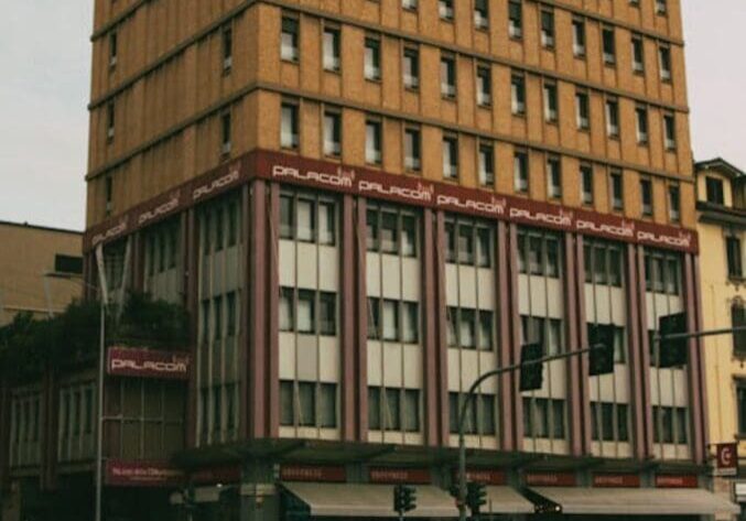 A large building with many windows on the side of it.